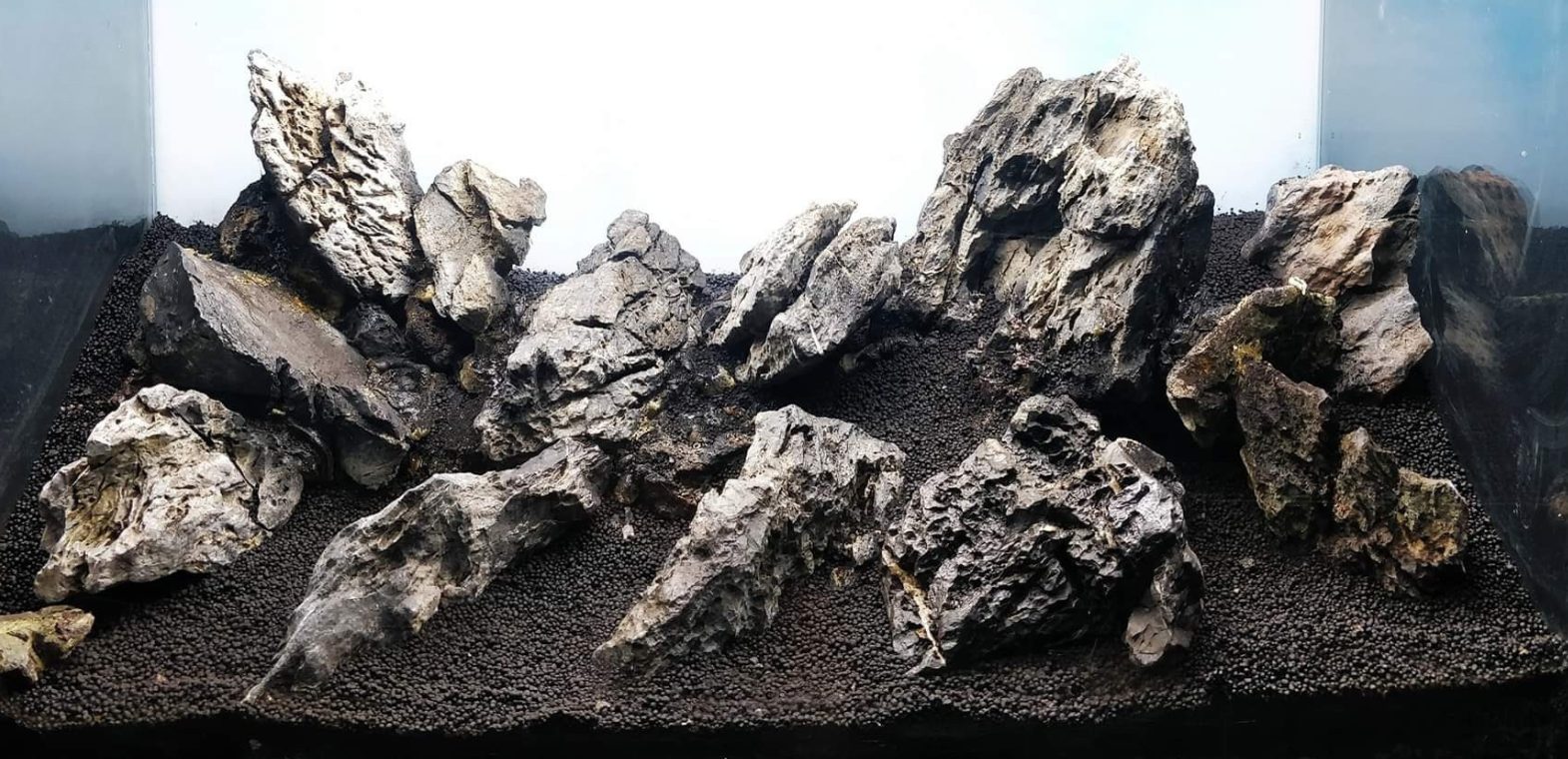 Iwagumi-style aquascape hardscape featuring Seiryu stones arranged on nutrient-rich aquasoil substrate in a planted aquarium, creating a minimalist mountain-inspired layout.